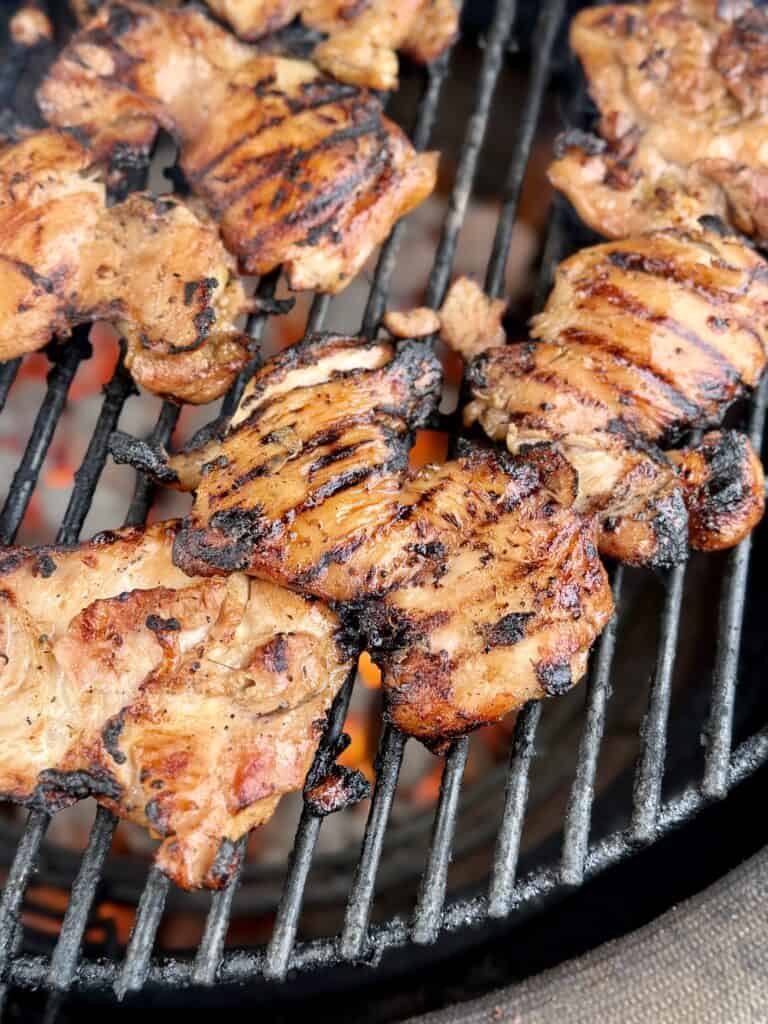 Chicken being cooked on a grill.