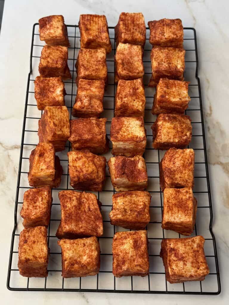 Pork Belly Burnt ends on wired rack.