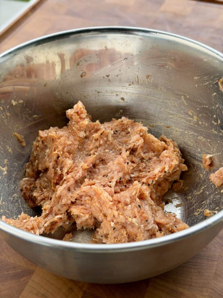 Chicken meat mixed in bowl.