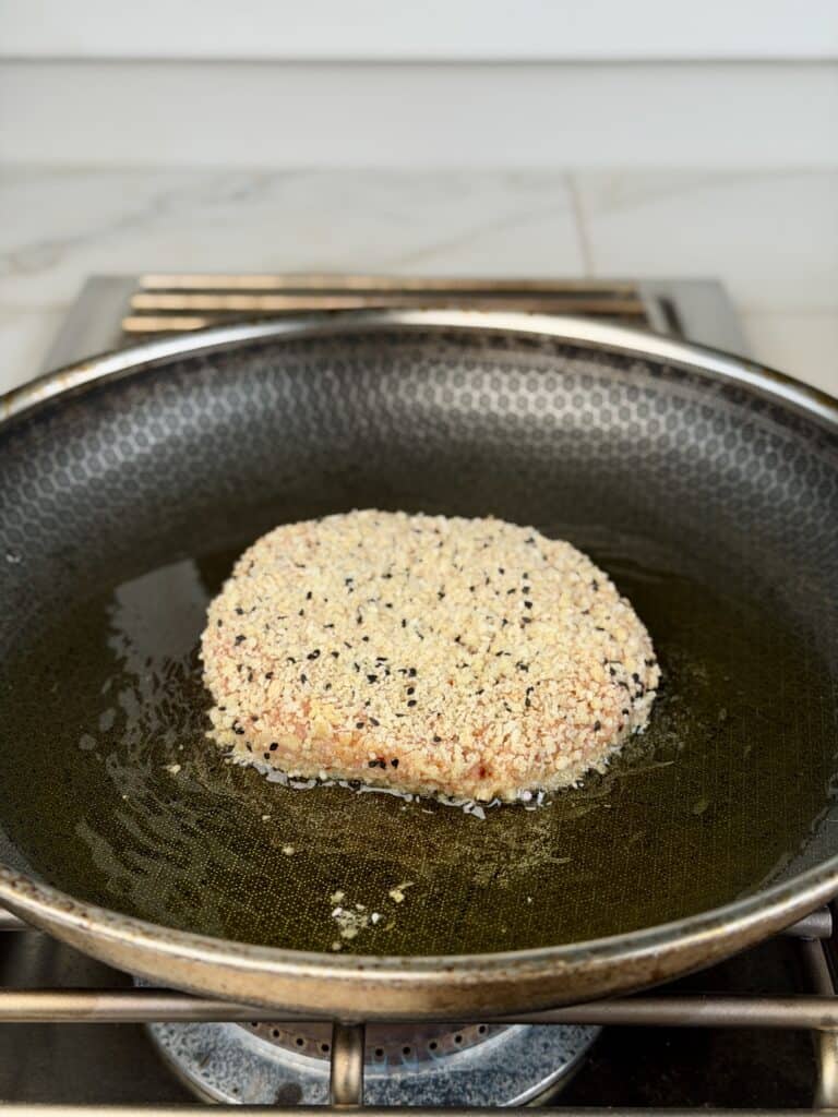 Chicken Patty in frying pan.