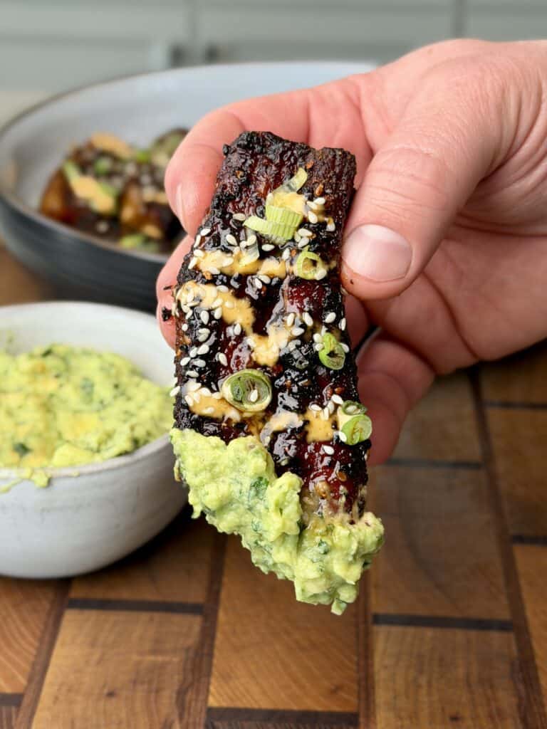 Asian Style Smoked Pork Belly dipped in Guacamole.