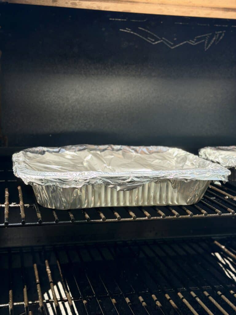 Covered Pan in Grill with BBQ Smoked Sausage Bites. 