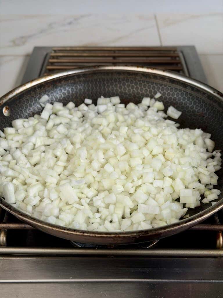 Onions cooking in skillet.