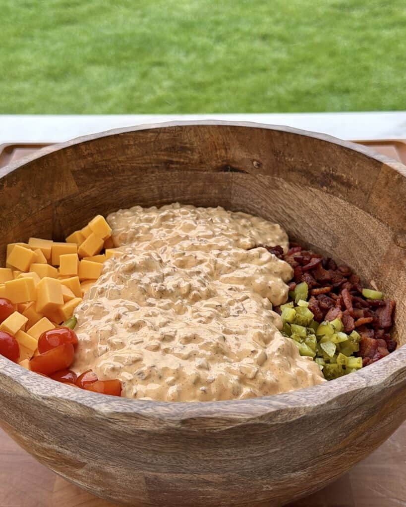 Bacon Cheeseburger Pasta Salad Ingredients in bowl with sauce.