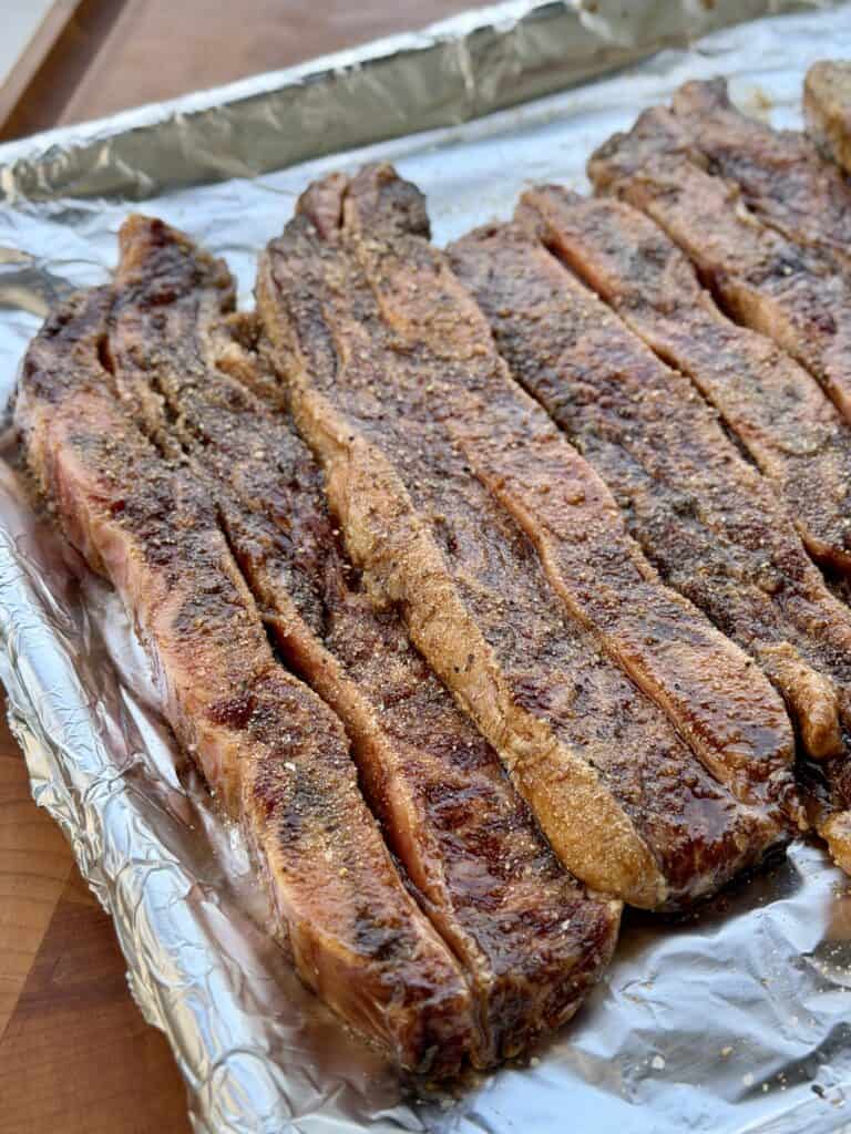 Short Ribs seasoned on foiled pan.
