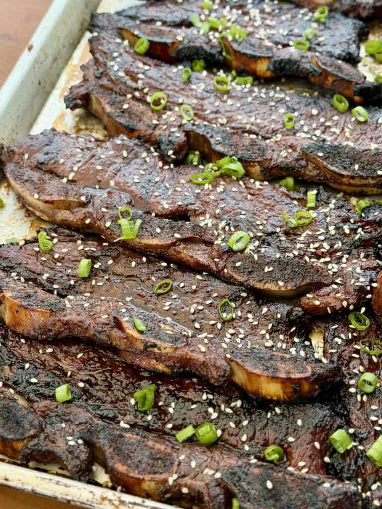 Green onions and Beef Short Ribs on pan.
