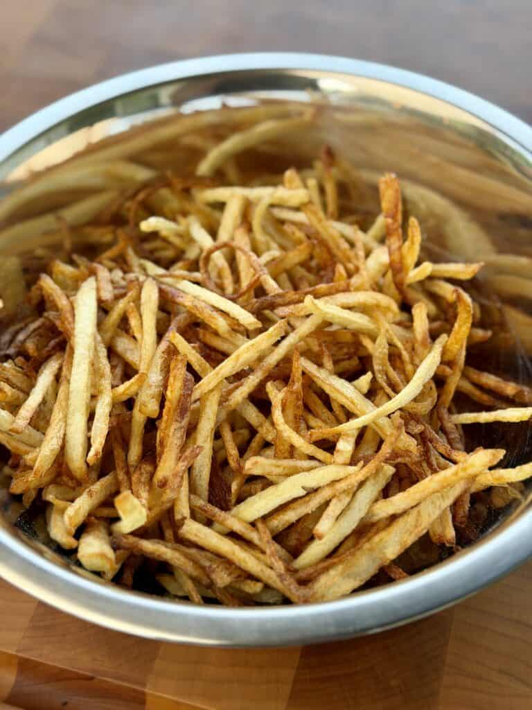 Cooked Potato Shoestrings in Bowl.