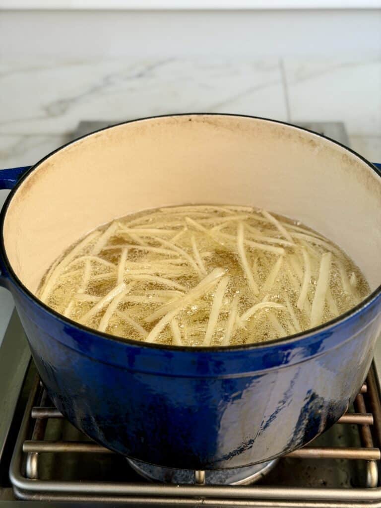 Potato Shoestrings Cooking in oil.