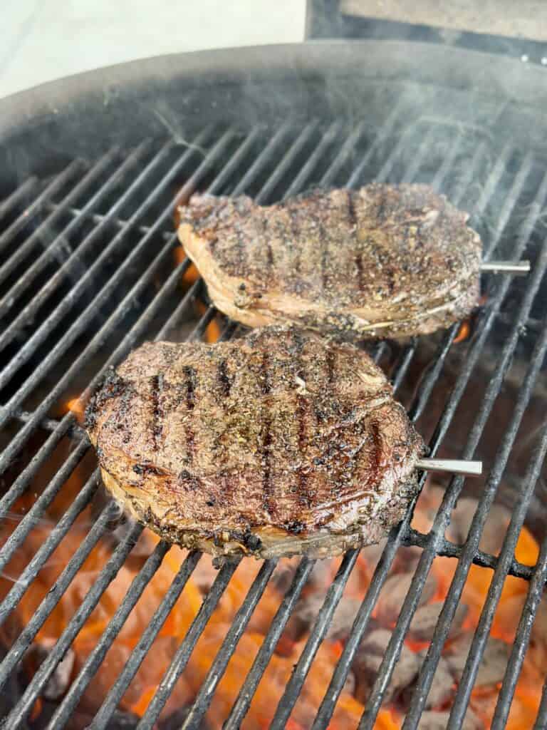 Grilled Steak Frites with Chimichurri, Ribeye Steak sitting on Grill.