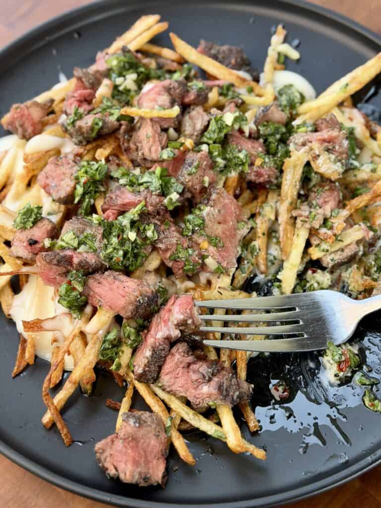 Grilled Steak Frites with Chimichurri on plate.
