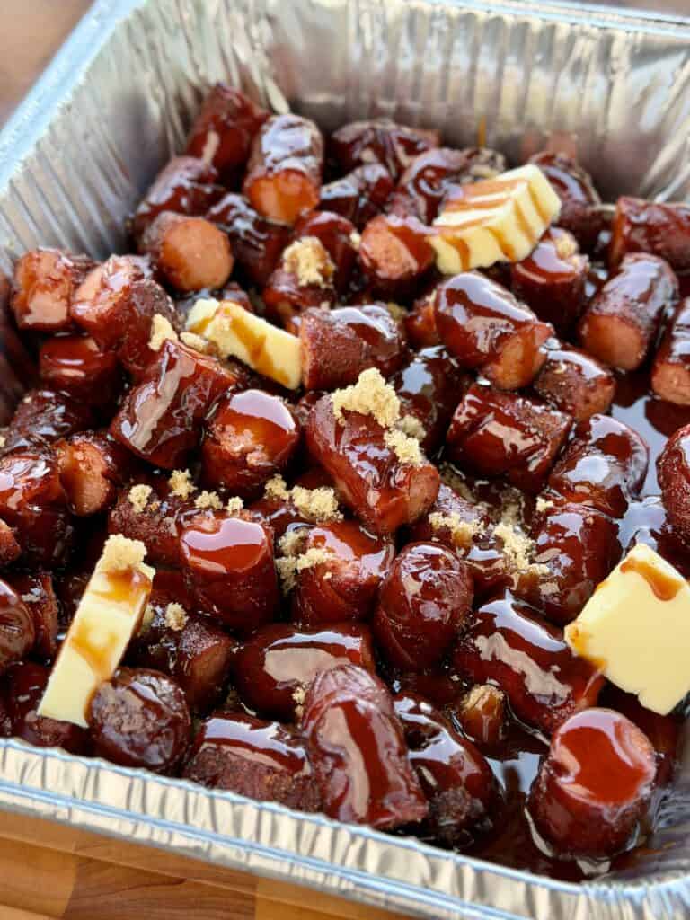 Hot Dogs with BBQ Sauce and Other Ingredients in Pan.
