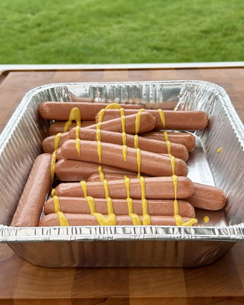 Hot Dogs with Mustard in Pan.