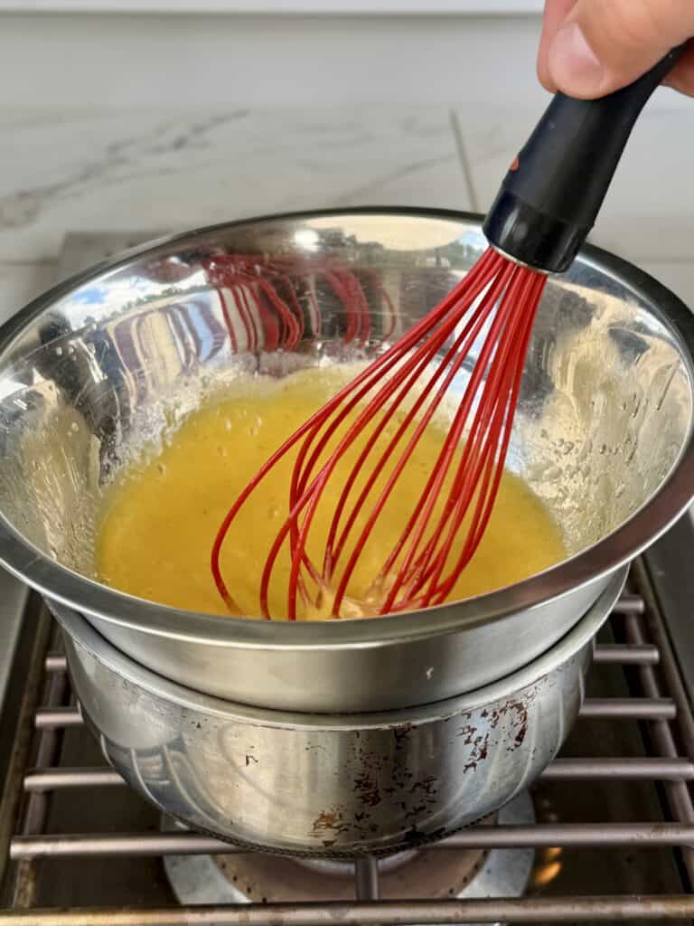 Sauce with whisk in bowl.