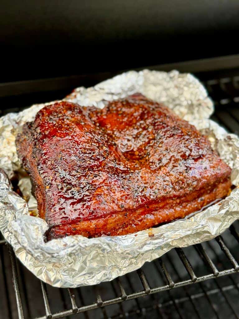 Pork Belly Eggs Benedict
meat on foil in smoker.