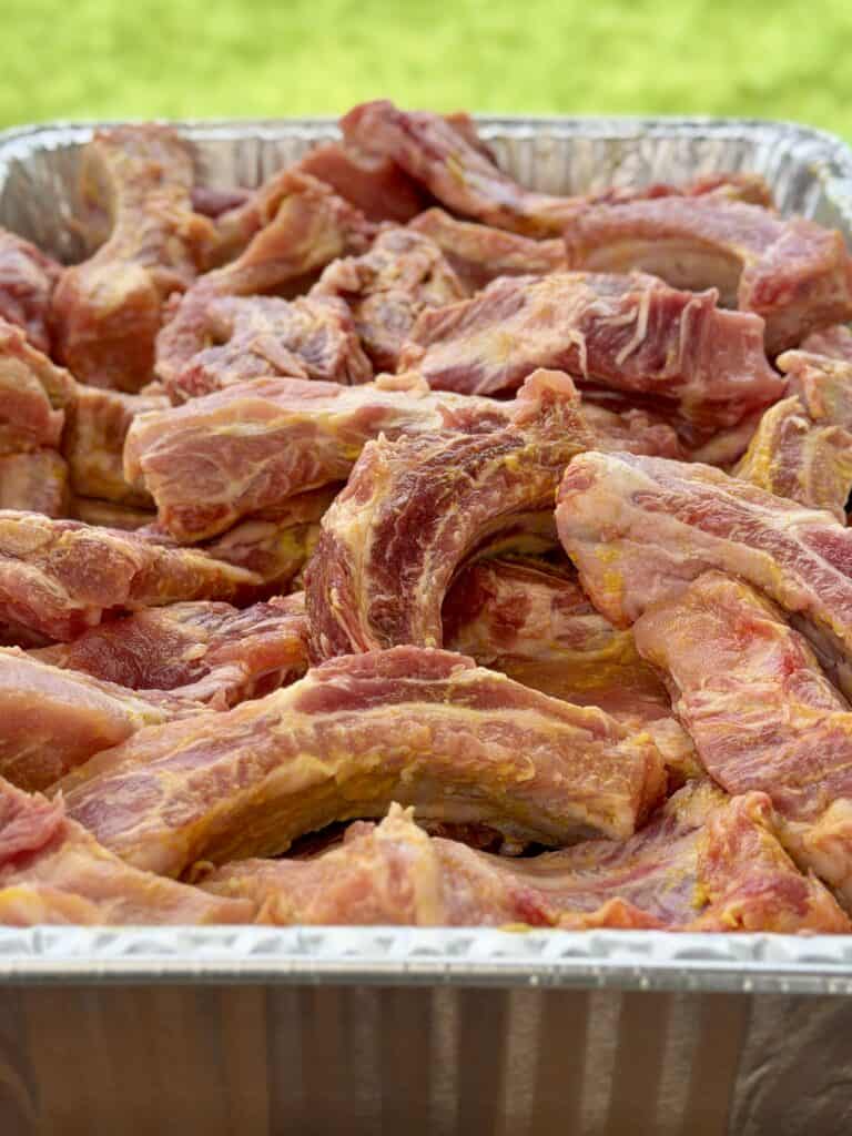 Yellow Mustard on Ribs in Pan.