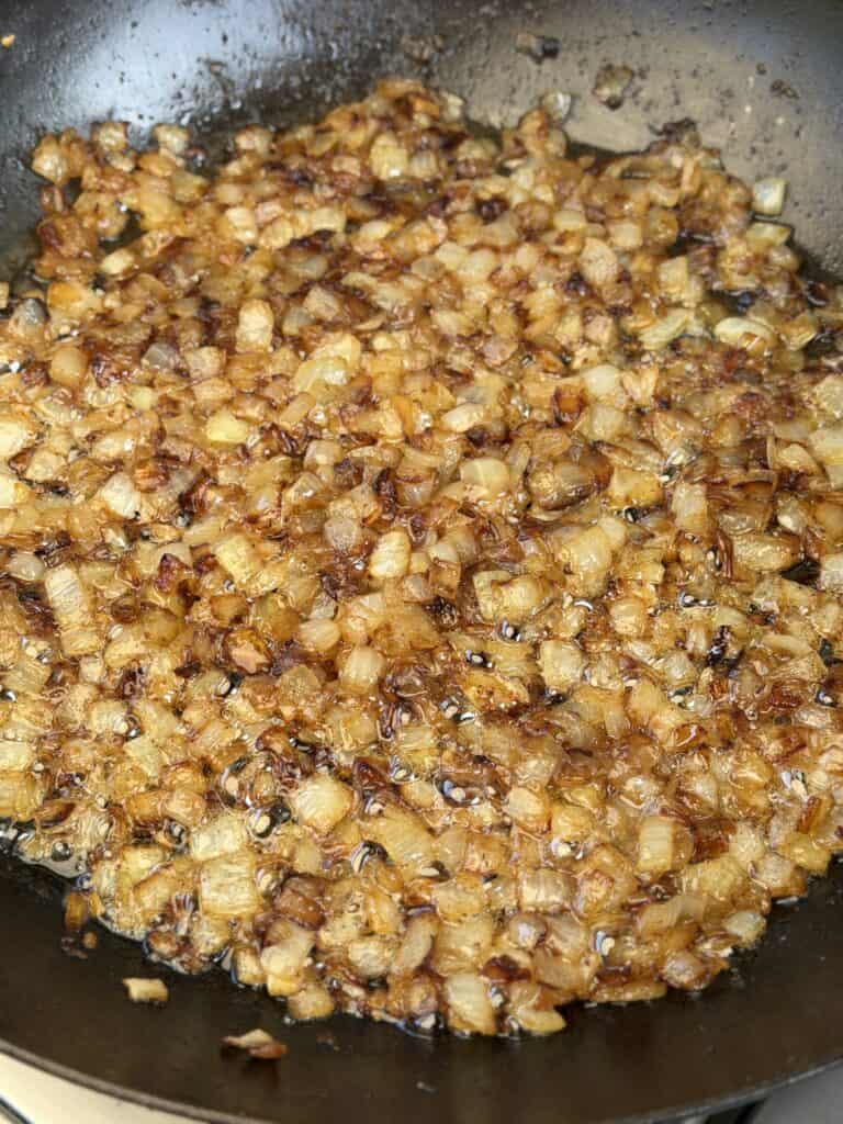 Onions cooking in pan.