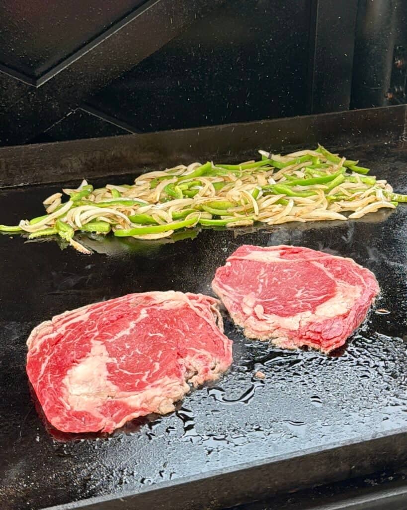 Shaved Ribeye steak on griddle.