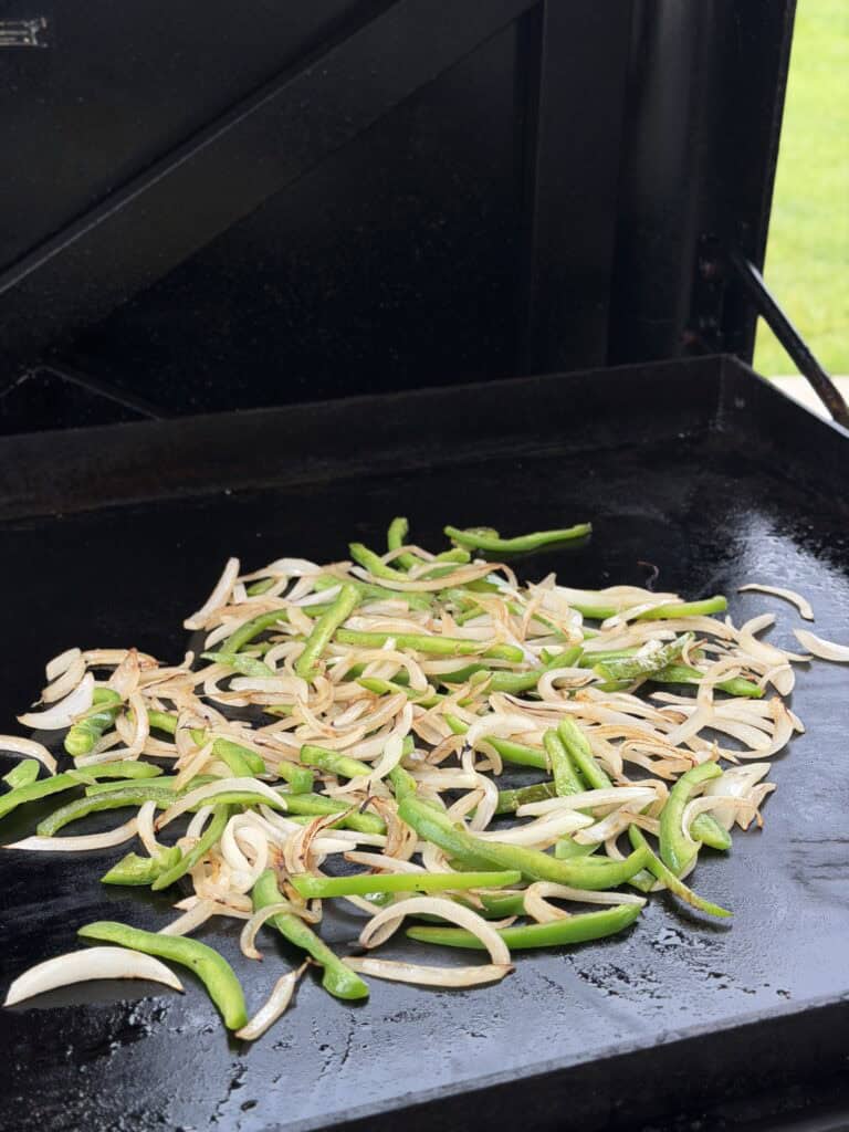 Peppers and onions on griddle cooked.