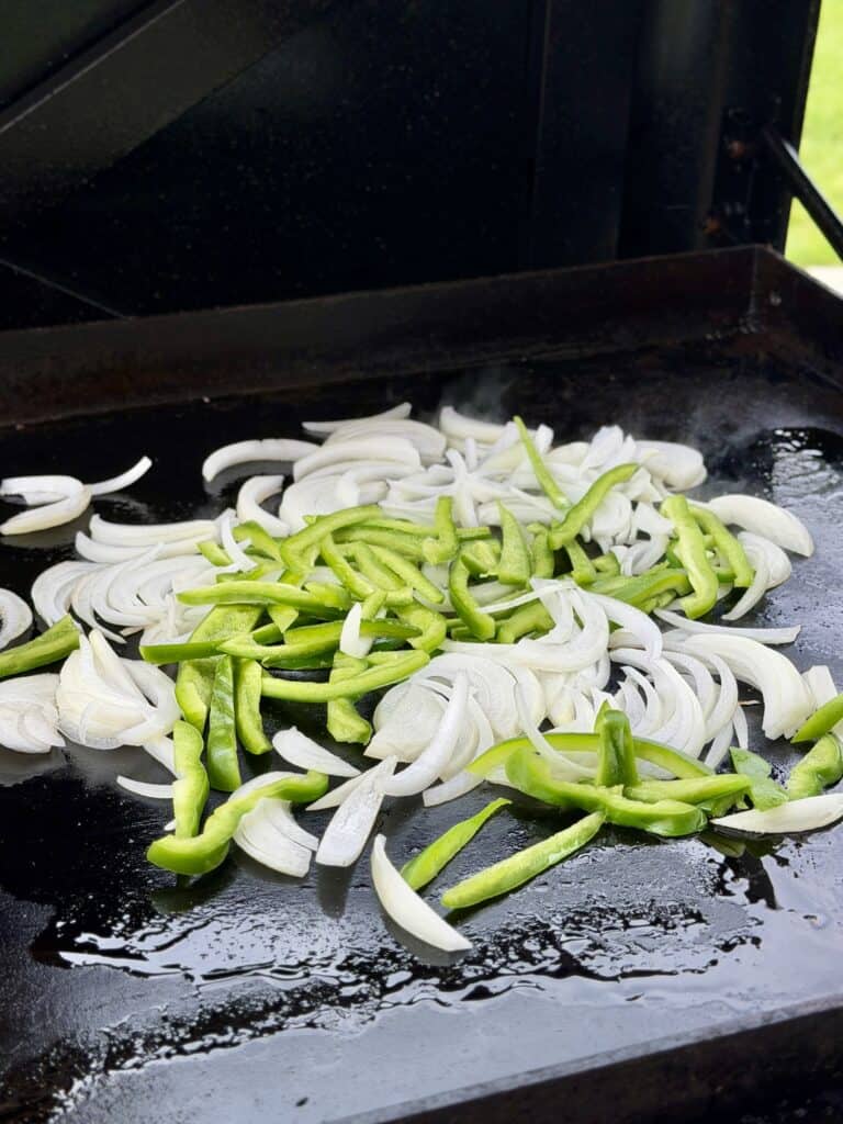 Onions and peppers on Griddle.