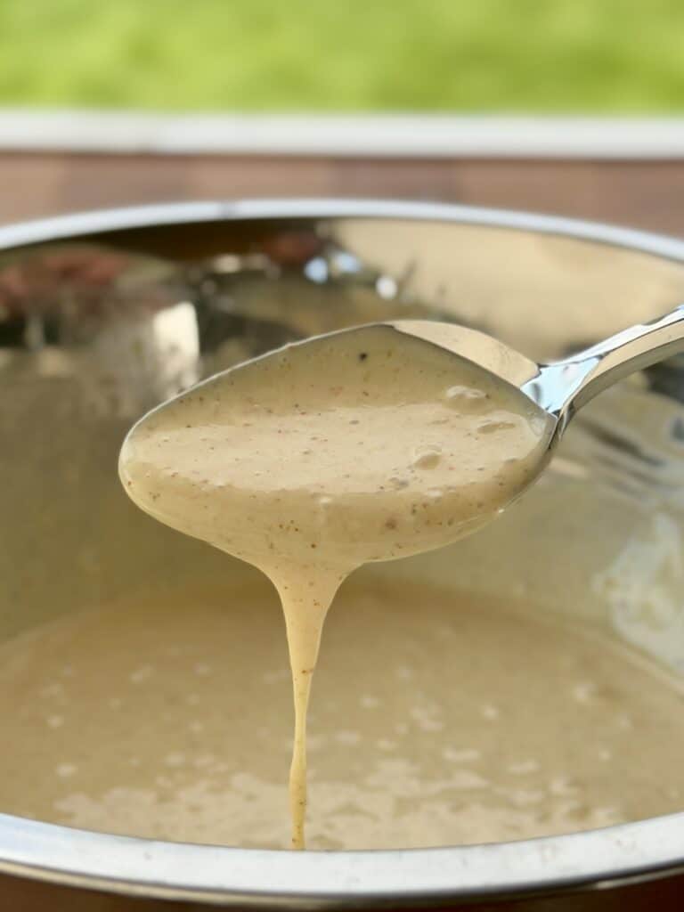 Alabama White sauce in a bowl with spoon.