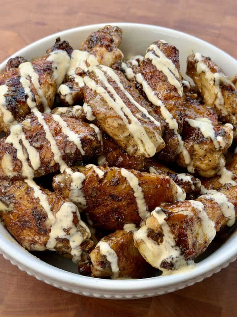Grilled Cajun wings with Alabama White Sauce.
