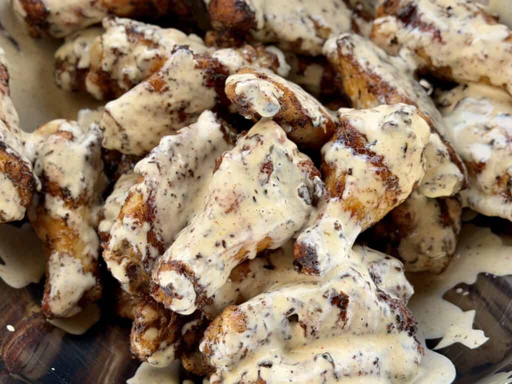 Grilled Cajun wings with Alabama White Sauce.