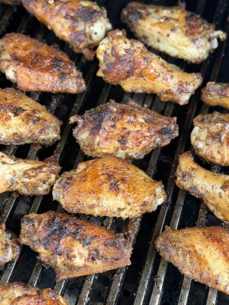 Chicken wings on the grill cooking.