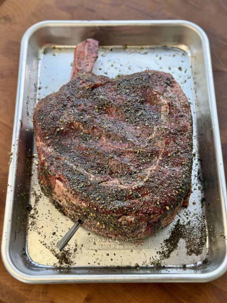Seasoned Ribeye on pan.