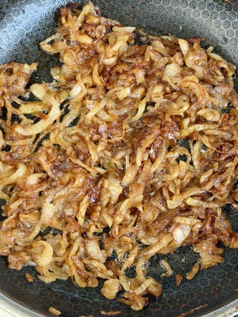 Cooked onions in pan.