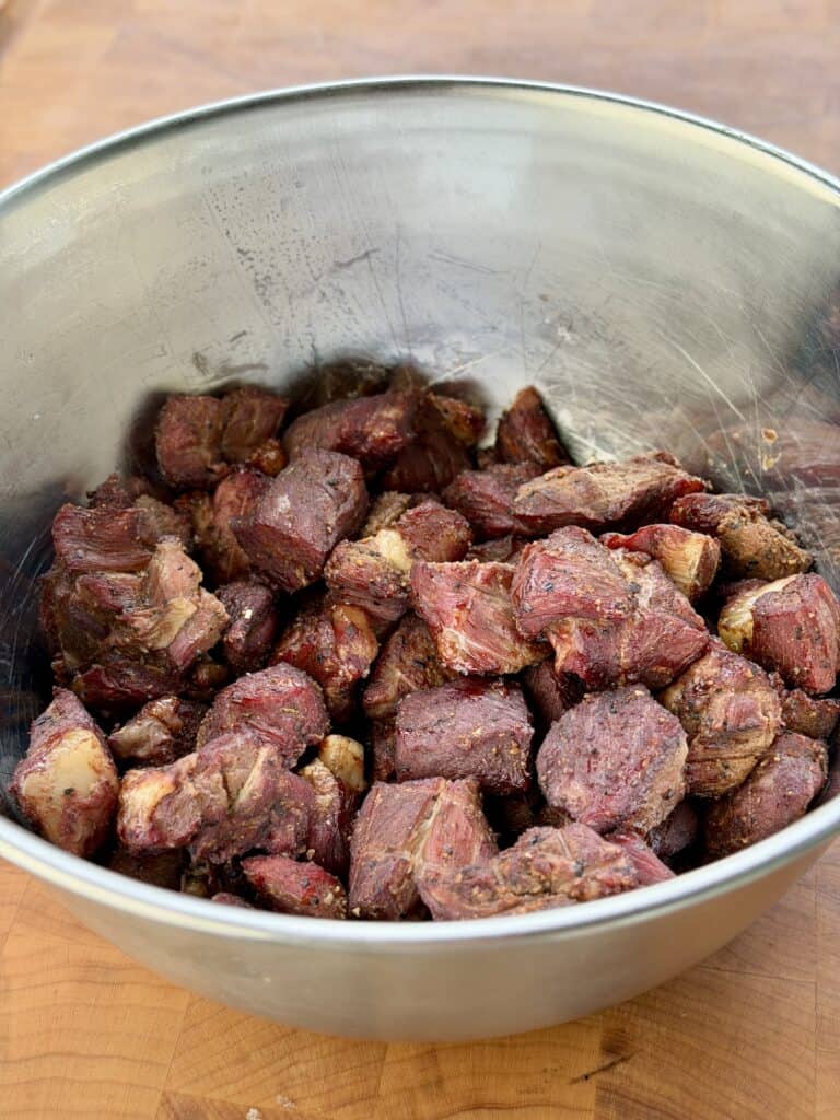 Smoked ed stew meat in bowl.