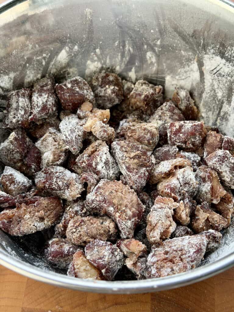 Beef Stew meat with flour coating in bowl.
