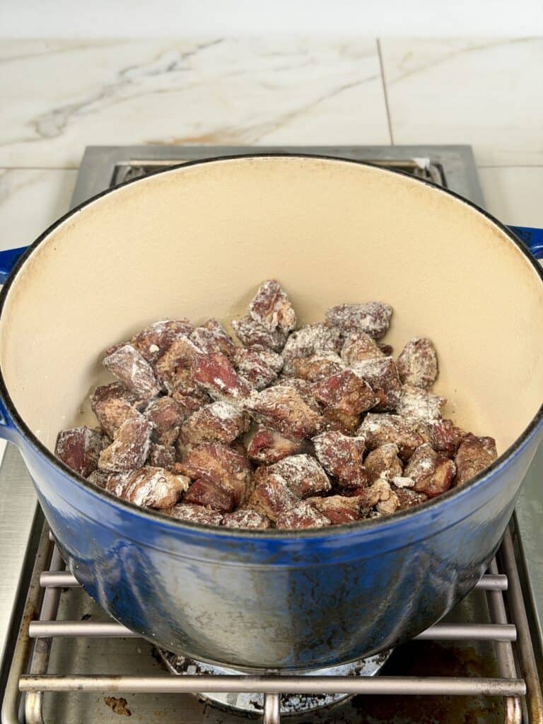 Floured Beef Stew meat in Dutch Oven.
