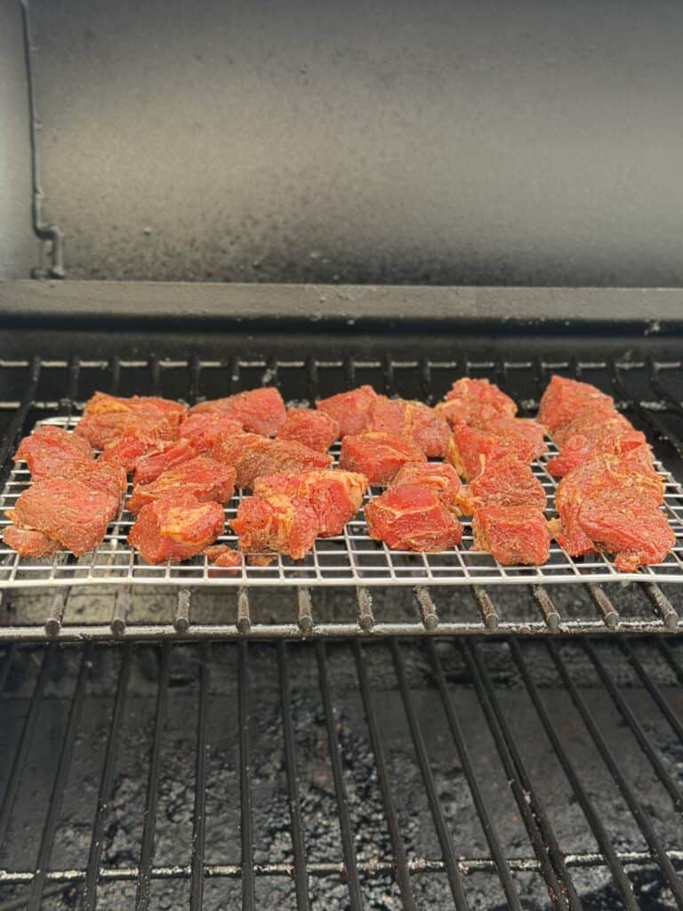 Beef stew meat on smoker.