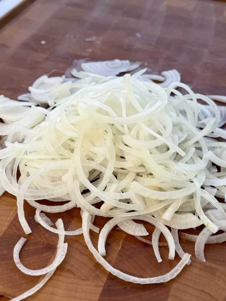 Sliced onion on cutting board.