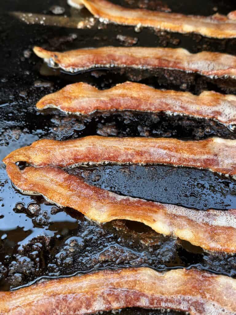 Bacon cooked on griddle for Rodeo Smashburger.