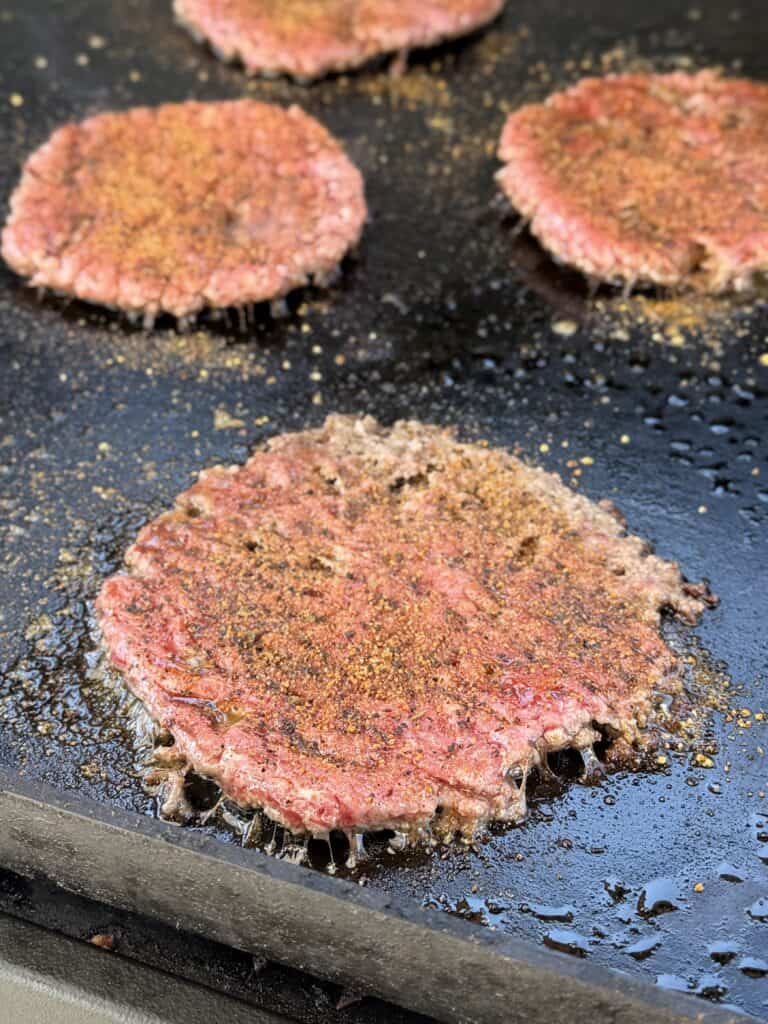 Rodeo Smashburger, seasoned burger on griddle.