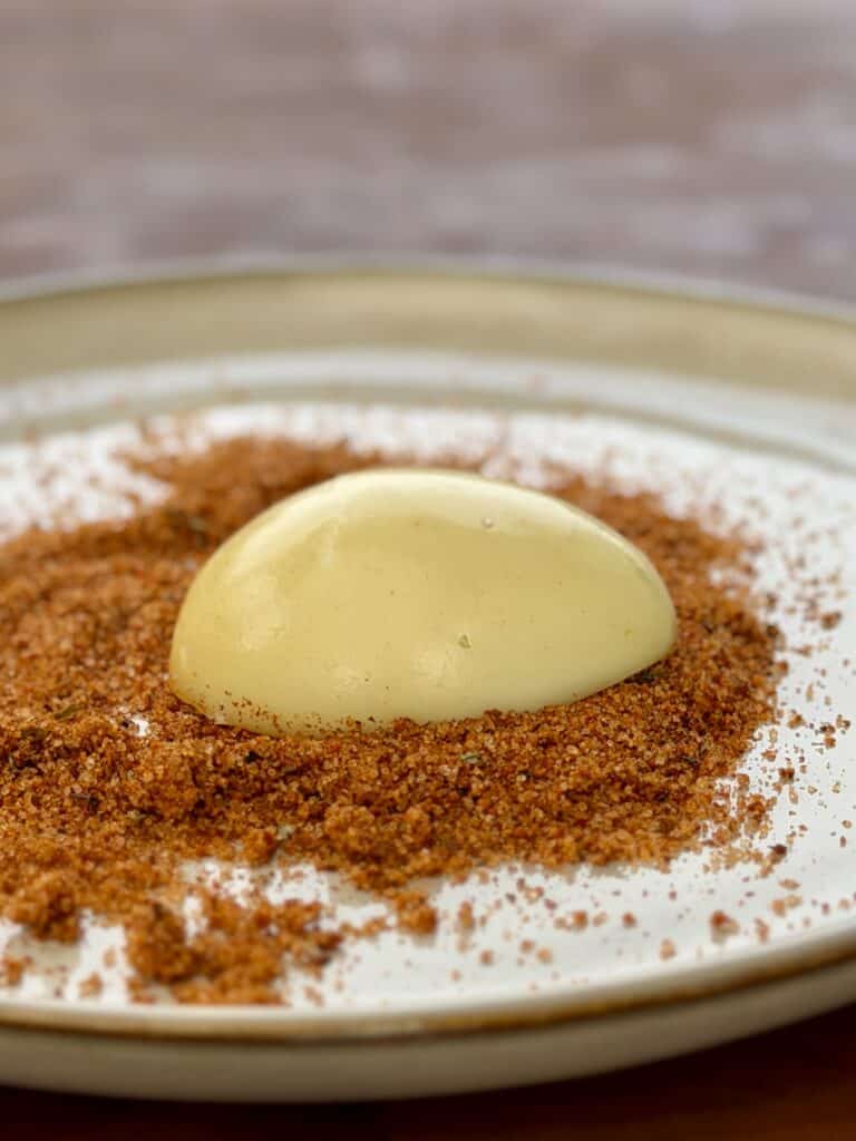 Egg in seasoning on plate.