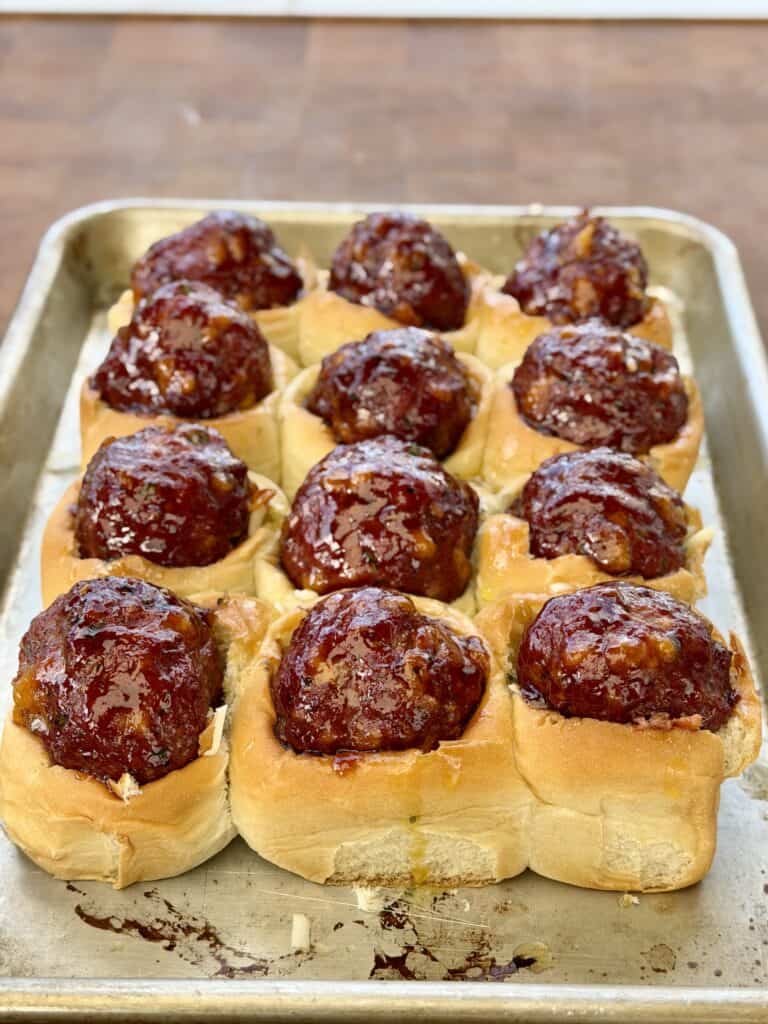 Meatballs in bun in pan.