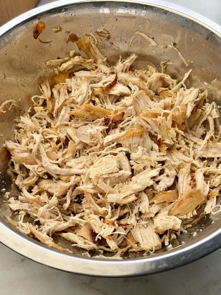 Shredded chicken in bowl.