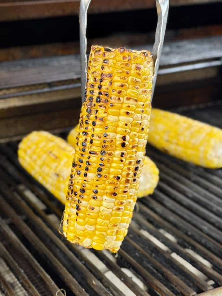 Grilled corn on grill.
