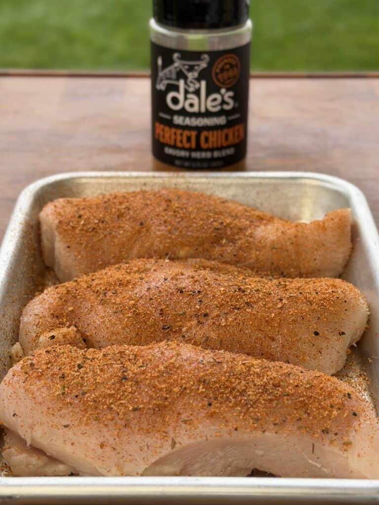 Seasoned chicken in pan.