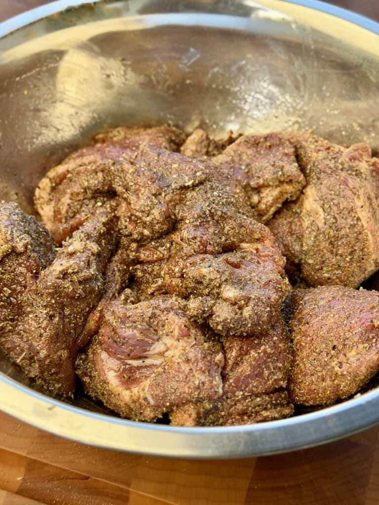 Seasoned ribs in bowl.